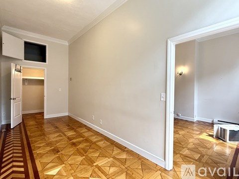 A bedroom with a large bed and a painting on the wall.