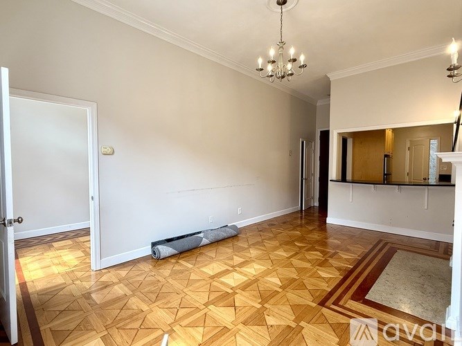 A living room with a grey couch and a fireplace.