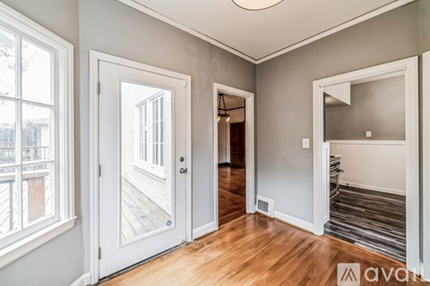 A room with a wooden floor and white walls.