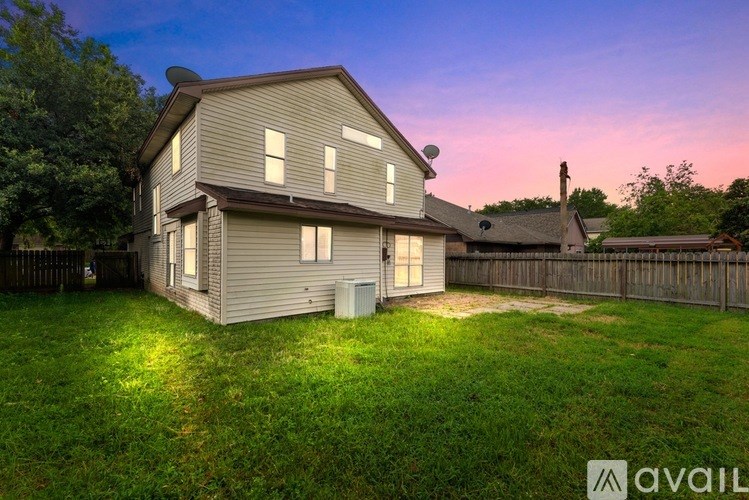 A spacious room with a ceiling fan and sliding glass doors.