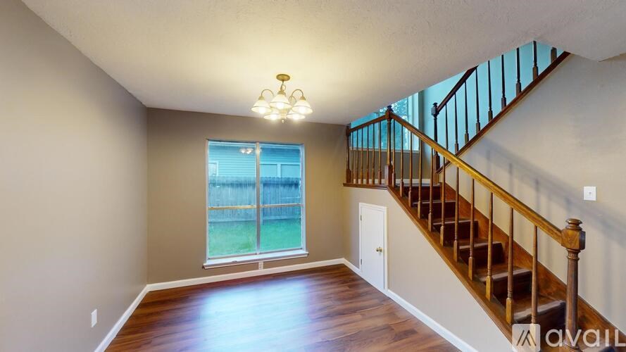 A room with a staircase leading to the upper floor.
