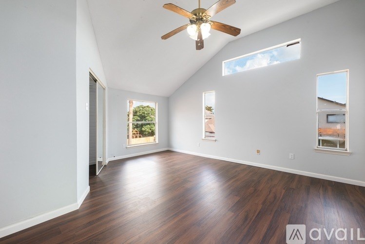 A spacious living room with a fireplace and a large mirror on the wall.