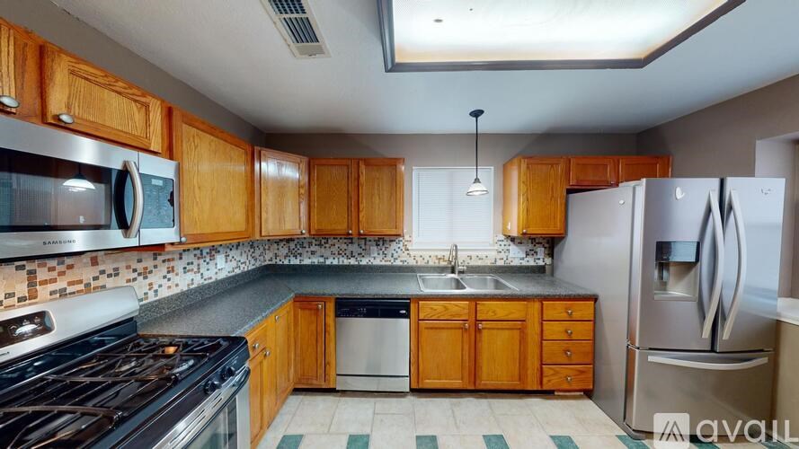 A kitchen with wooden cabinets and a black stove top oven.