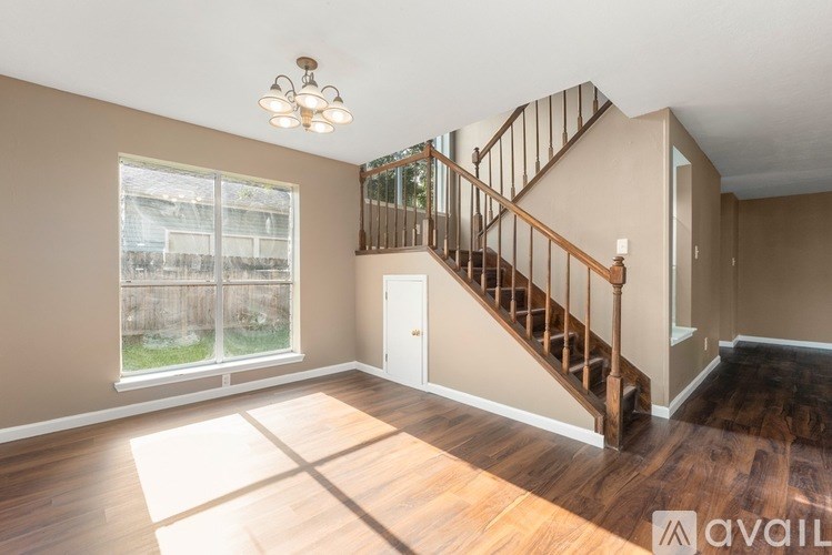 A spacious living room with a fireplace and large windows.