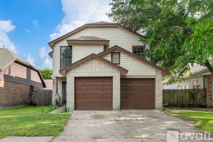 A bathroom with a large counter and a glass shower door.