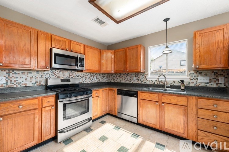 A bathroom with a toilet, sink, and bathtub.