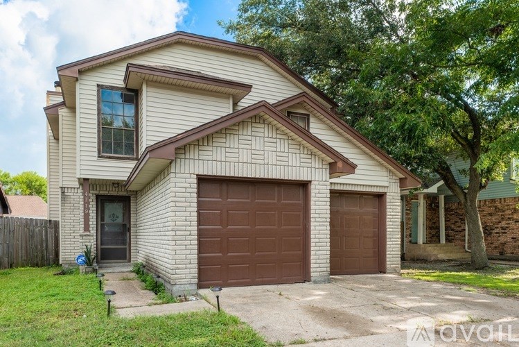 A white wall with a wooden floor and a window.
