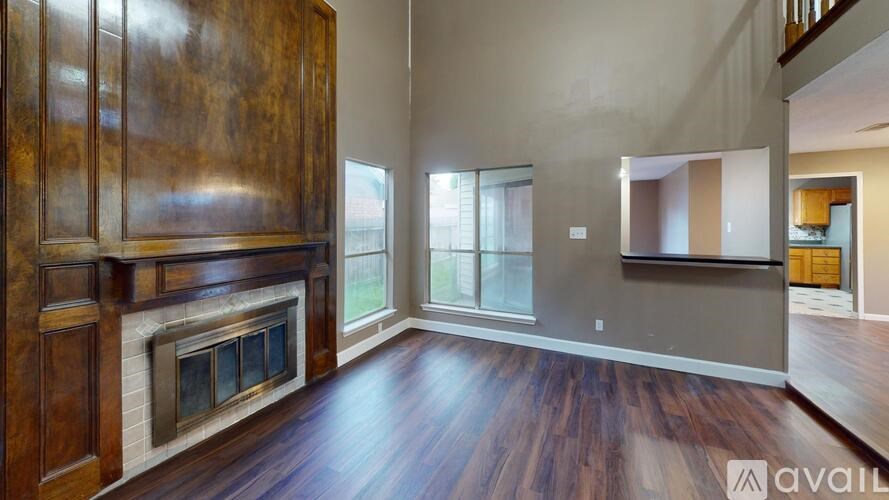 A room with wood floors and a fireplace.