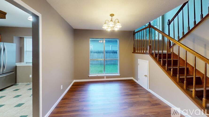 A spacious room with a staircase leading to the upper floor.