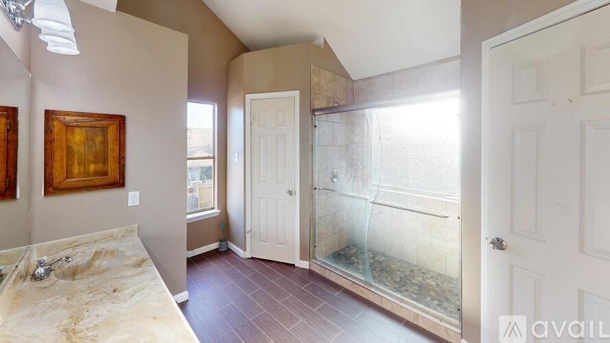 A room with a marble countertop and a glass door leading to a balcony.