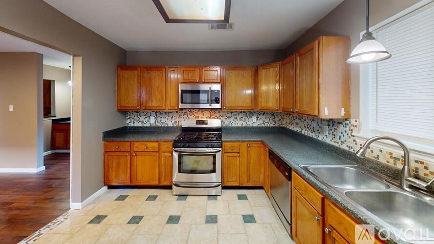 A kitchen with wooden cabinets and a black stove top oven.