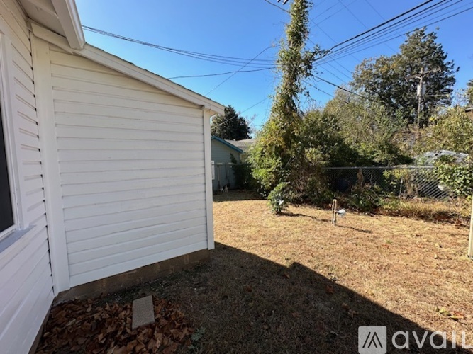 A backyard with a shed and trees.