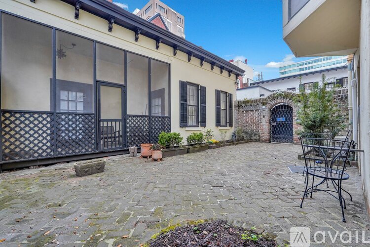 A patio area with a table and chairs outside a building.