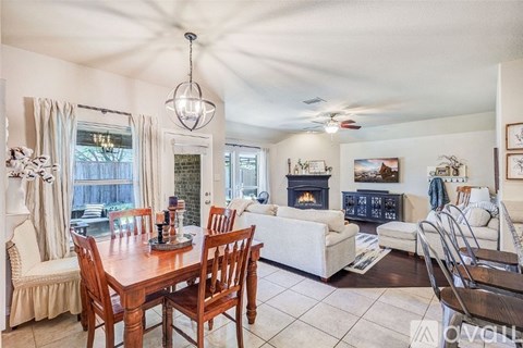 A dining room with a wooden table and chairs.