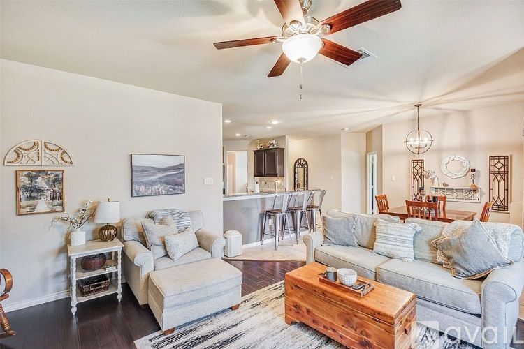 A living room with a grey couch and a wooden coffee table.