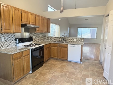 A kitchen with wooden cabinets and a black and white checkered backsplash.