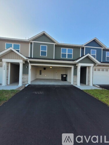 A house with a grey garage door is for sale.