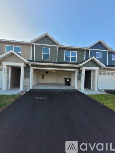 A house with a grey garage door is for sale.
