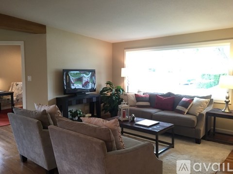 A living room with a television and a couch.