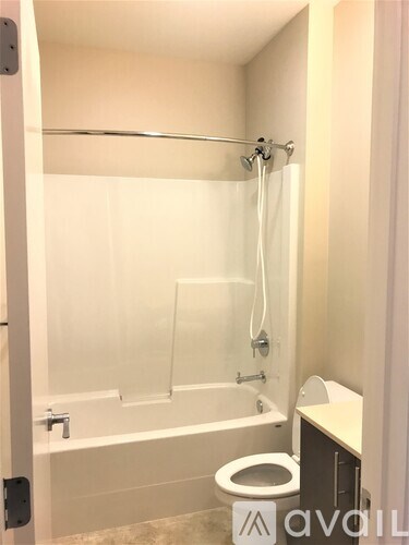 A bathroom with a toilet, sink, and bathtub.