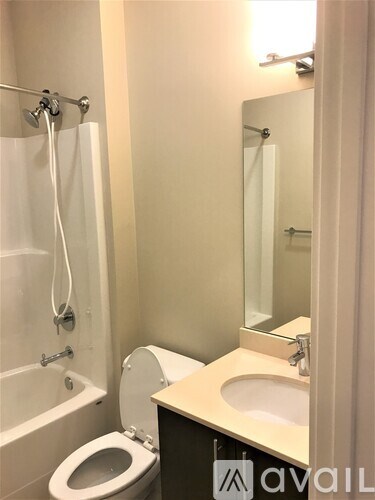 A bathroom with a toilet, sink, and bathtub.