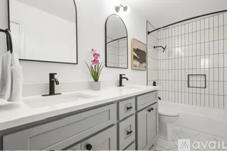 A bathroom with a white sink and a white towel hanging on the wall.