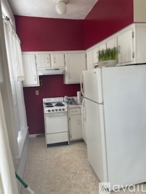A kitchen with a white fridge, stove and oven.