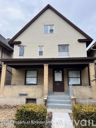 A two-story house with a brown door and windows.