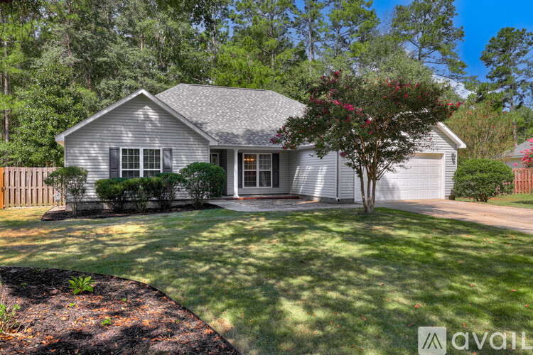 A house with a white garage door and a mailbox in front.