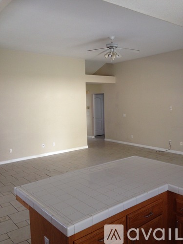 A room with a tiled floor and a ceiling fan.