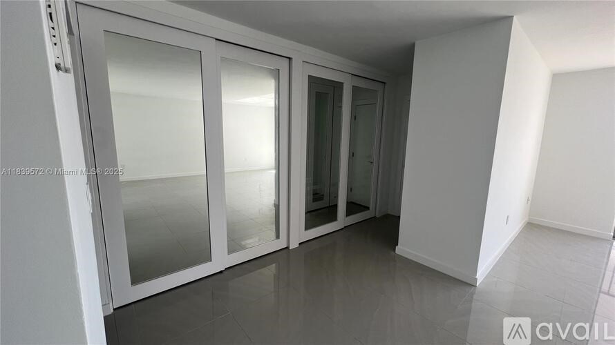 A room with a glass door and a white wall.