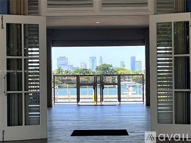 A view of a city skyline is visible through a sliding glass door.