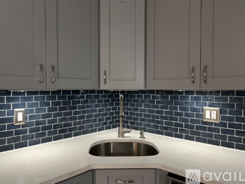 A kitchen with a sink and cabinets.