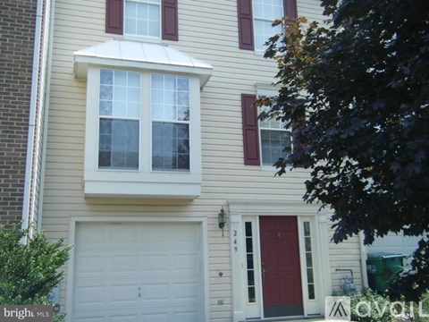 A house with a red door and a white garage door.