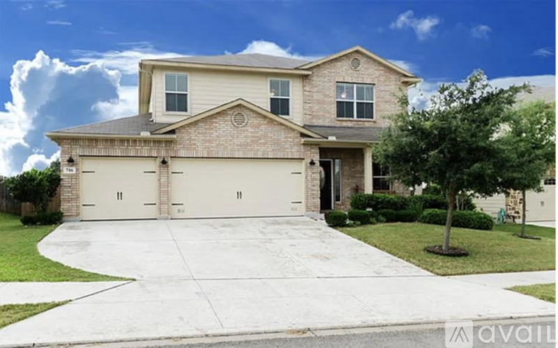A large house with a driveway in front.