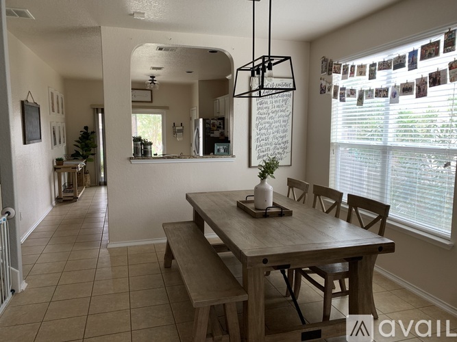A dining room with a wooden table and chairs.