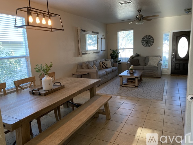 A living room with a wooden table and a couch.