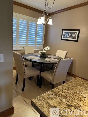 A dining room with a table set for four.