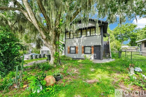 A house with a tree in front of it.