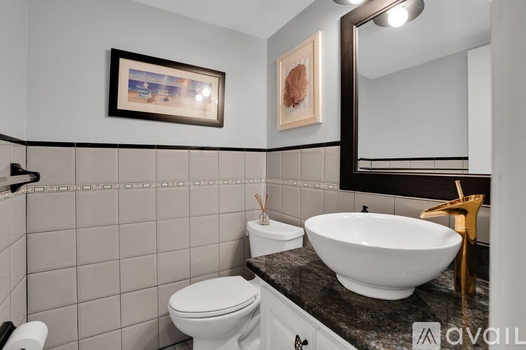 A bathroom with a white toilet, a white sink, and a mirror.