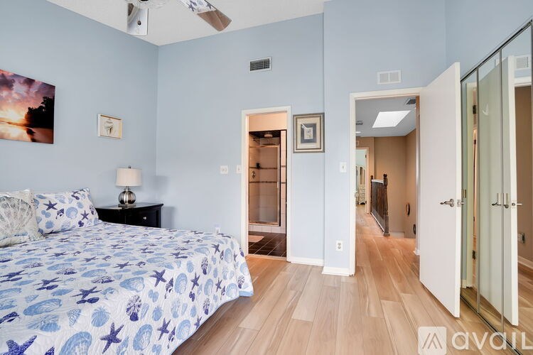 A bedroom with a bed, dresser, and mirror.