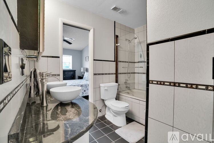 A bathroom with a sink, toilet, and shower.