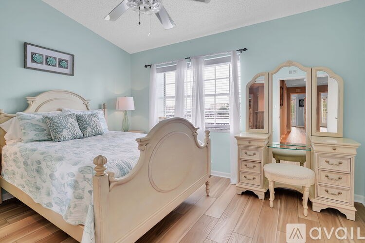 A bedroom with a bed, dresser, and mirror.