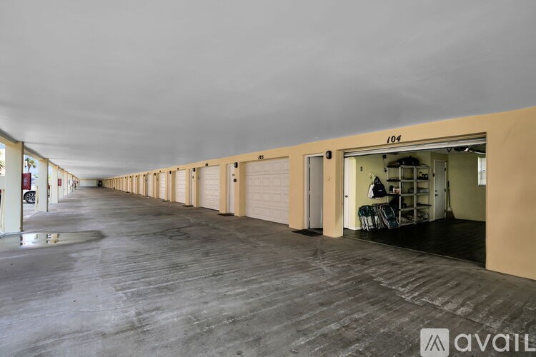 A long hallway with numbered doors leading to storage units.