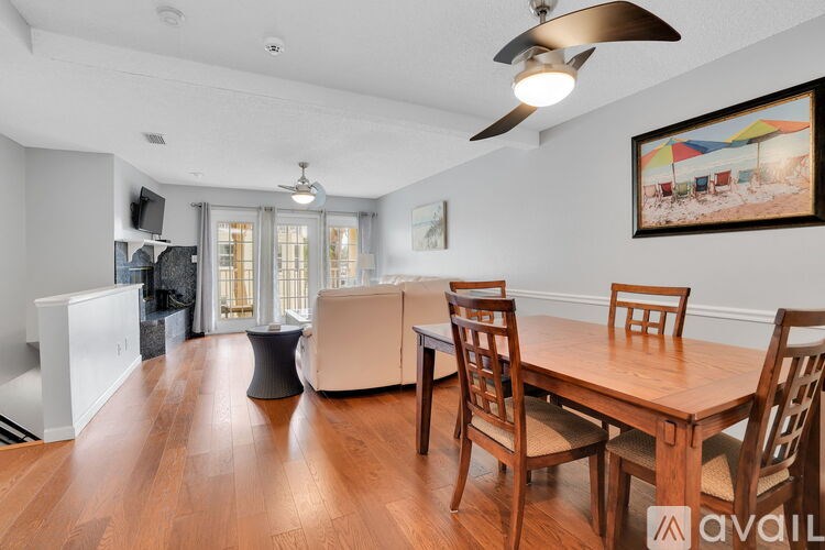 A dining room with a wooden table and chairs.