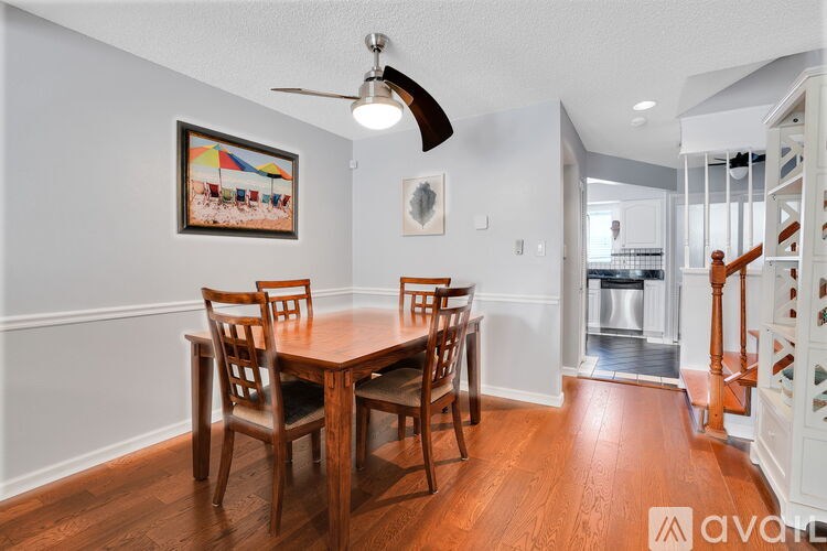 A dining room with a wooden table and chairs.
