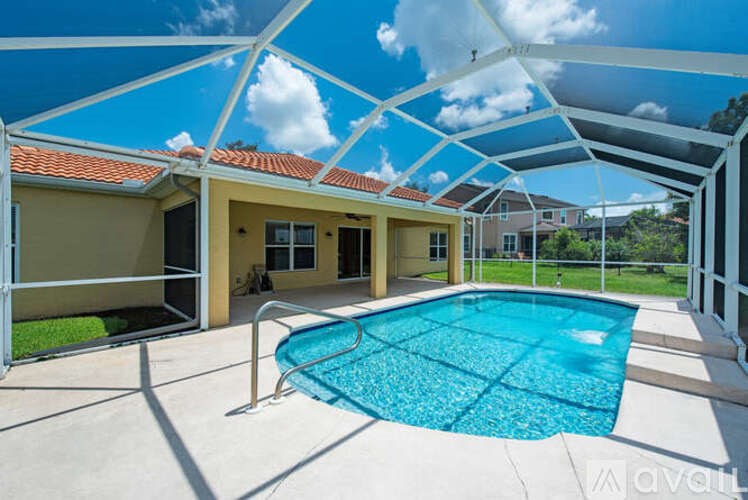 A house with a pool under a white canopy.