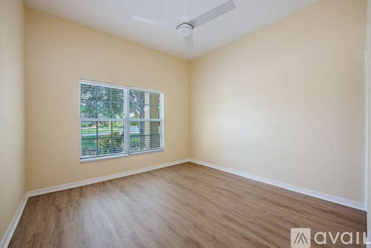 A room with a window and wooden flooring is available for rent.