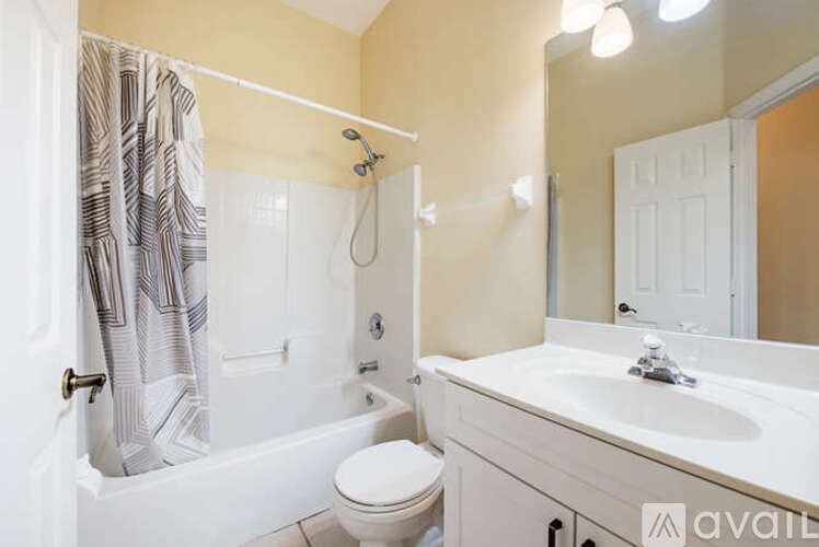 A bathroom with a toilet, sink, and bathtub.