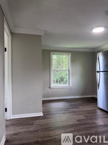 A kitchen with a refrigerator and a window.